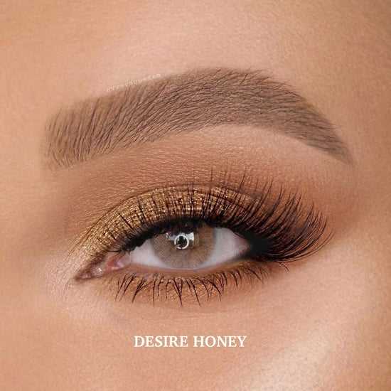 Desire Honey colored contact lenses with a deep hazel-brown shade, slightly darker than Hidrocor Ocre for a rich, natural look.