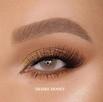 Desire Honey colored contact lenses with a deep hazel-brown shade, slightly darker than Hidrocor Ocre for a rich, natural look.