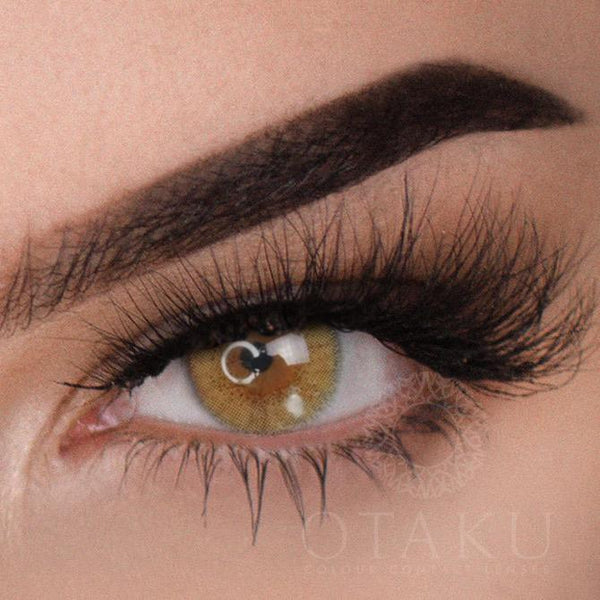 Before and after transformation with Kryptonite Green Otaku colored contact lenses on dark brown eyes."