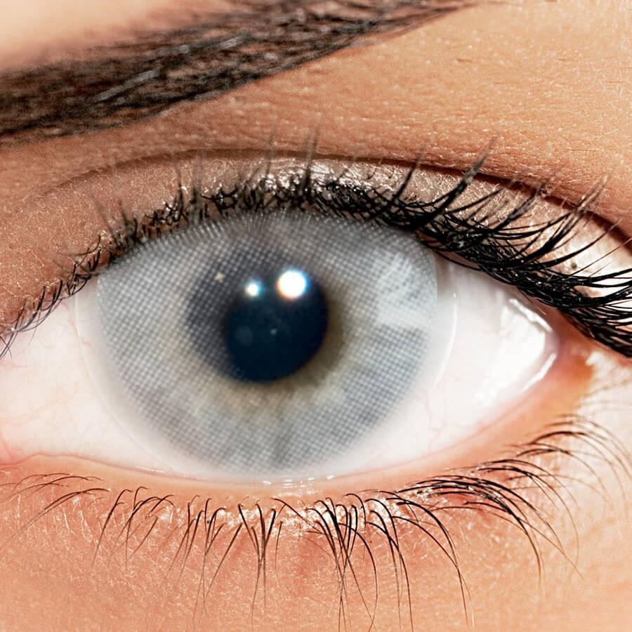 Solotica Hidrocor Cristal colored contact lenses before and after transformation on dark eyes.