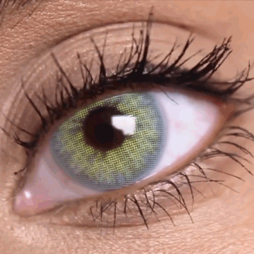 Before and after transformation using Solotica Hidrocor Rio Ipanema green contact lenses on dark brown eyes.